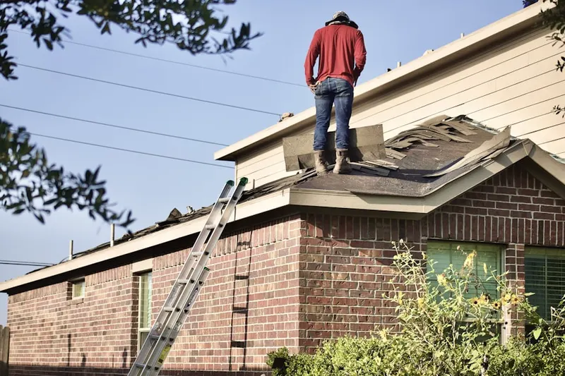 Professional roofer working on a residential roof in Chapman Farms